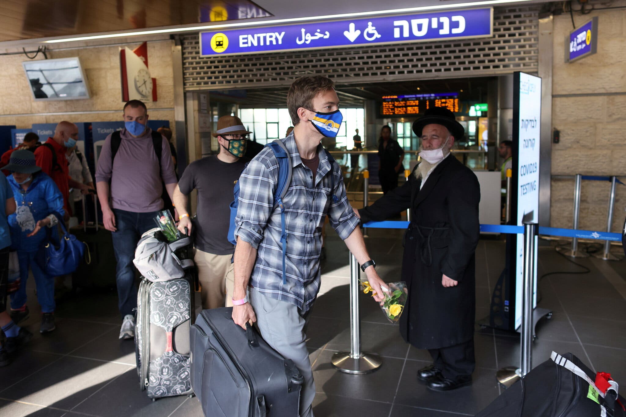 Pessoas que chegaram ao Aeroporto Internacional Ben Gurion em Lod, perto de Tel Aviv, em maio passado, quando parentes imediatos que foram vacinados foram autorizados a entrar no país. (Crédito: Ronen Zvulun / Reuters)